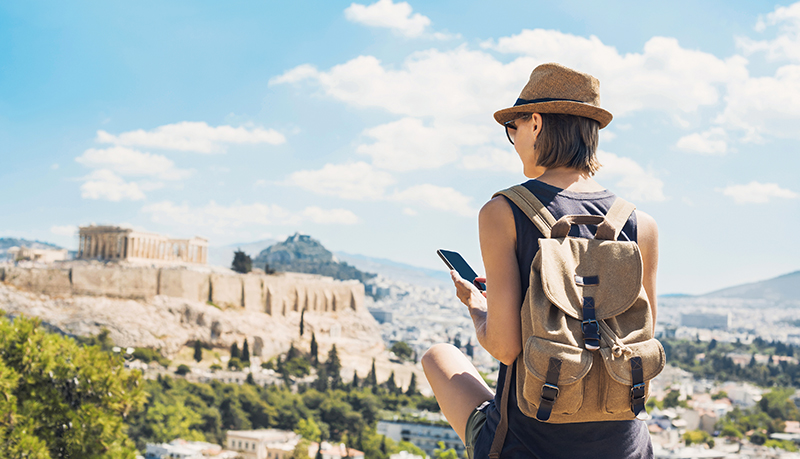 Person with backpack posting social media photo in scenic lookout in Rome | Alliant Private Client