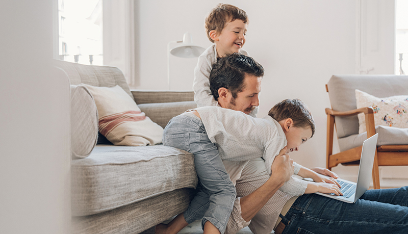 Children playing with Dad and laptop | Alliant Private Client